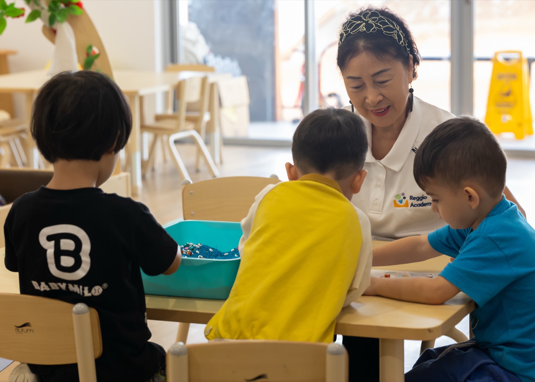 An educator working with children at a table