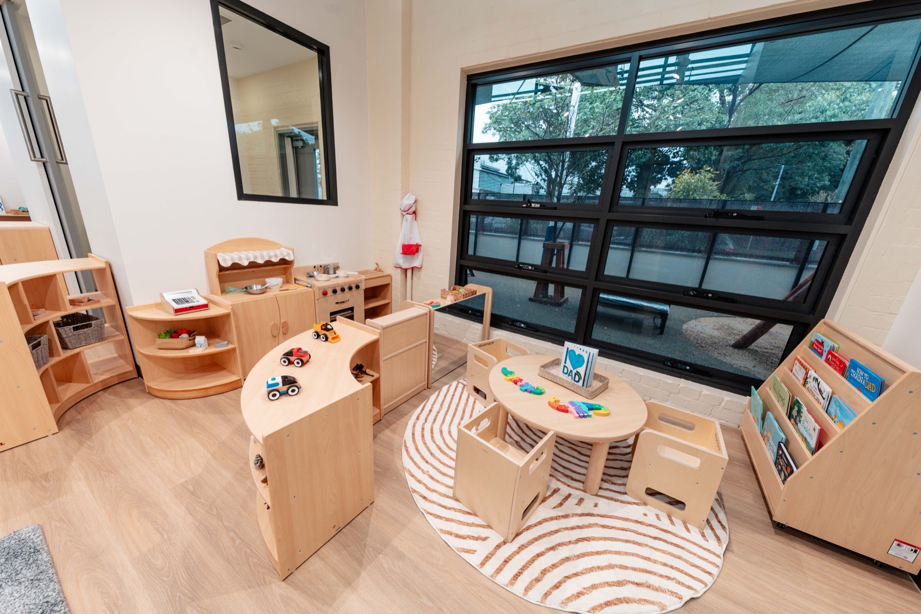 A reading corner with timber shelves and a round table